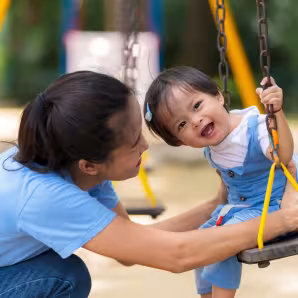 Mother and daughter playing on a playground