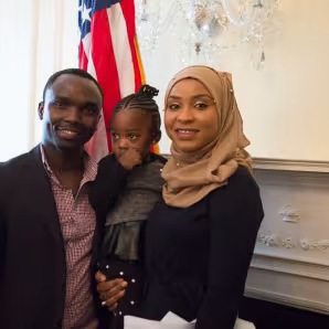 Parents and their young child at a naturalization service.