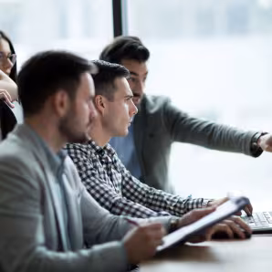 A group of coworkers at a computer