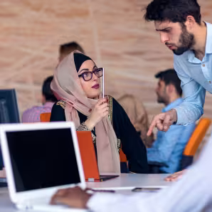 A group of office workers with laptops