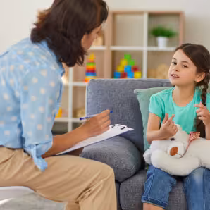 Young girl talks to a child psychologist