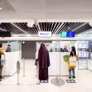Three refugee students at airport security check