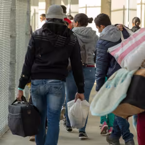 Inadmissible migrants, some seeking asylum, are processed by CBP officers