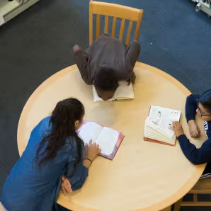 Middle school students studying in a library