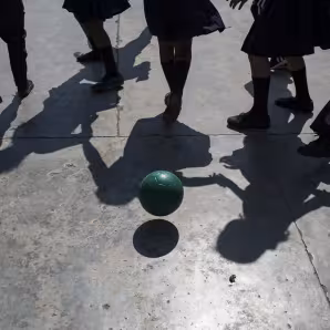 Children at a school in Honduras play with a soccer ball