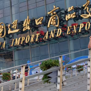 Image of man on steps in front of China Import and Export Fair in Guangzhou, China