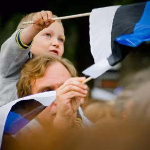 A father and son wave flags at the Estonian Song Festival in Tallinn.
