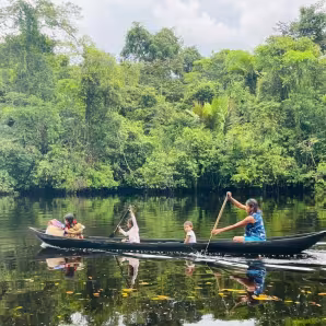 Image of indigenous Warao in a canoe on the Kaituma River in Guyana