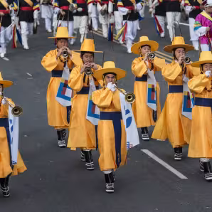 Korean band members march in a parade