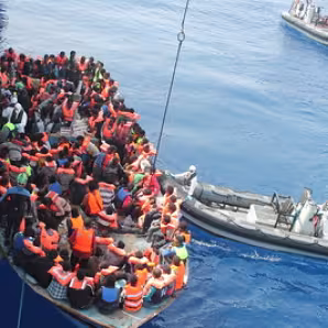 Migrants aboard a rubber vessel are rescued in the Mediterranean