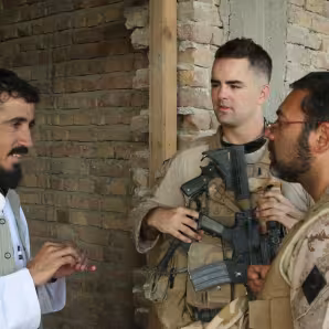 An Afghan man speaks to an interpeter working with the U.S. Marine Corps.