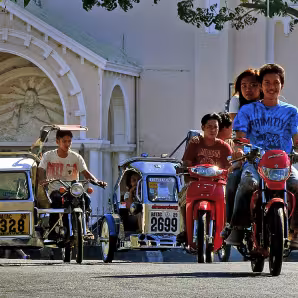 Young people ride motorcycles in Batac, Philippines.