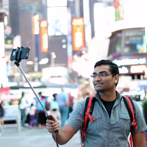 A tourist takes a selfie in New York City.