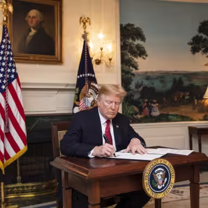 President Trump signs an immigration proclamation at the White House