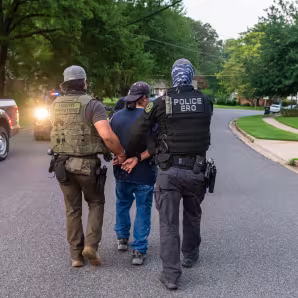 Federal immigration officers make an arrest during an operation in Virginia.