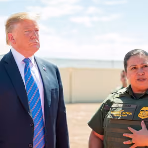 President Trump and a Customs and Border Patrol officer stand together