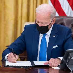 President Joe Biden signs executive orders on immigration in the White House.