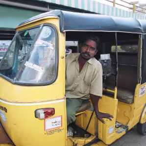 A tuk tuk driver in India.
