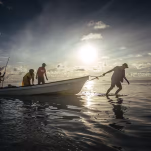 A man pulls a boat on the low-lying Carteret Islands in Papua New Guinea
