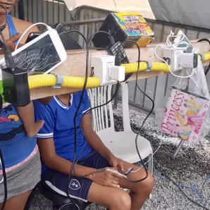 Venezuelan migrants charge their phones and other devices at a power point in Boa Vista, Brazil.