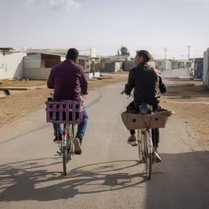 People ride bicycles in the Za'atari refugee camp in Jordan.