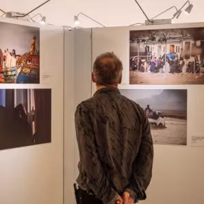 A person views photos in an art exhibition