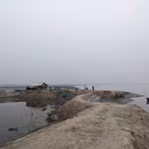 People walk along an embankment in Bangladesh