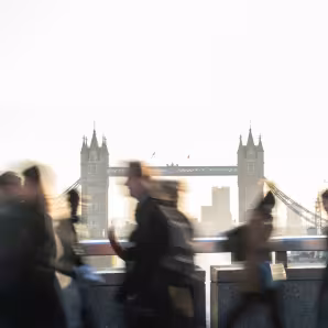 People walk in front of Tower Bridge in London.