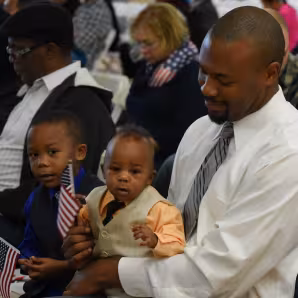 A man and child at a naturalization ceremony outside Washington, DC.
