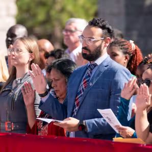 Immigrants take the oath of allegiance during a naturalization ceremony.