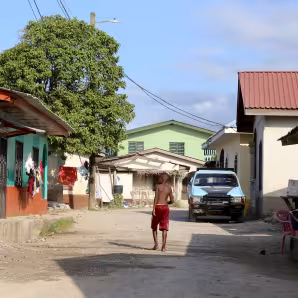 A boy walks through a coastal village in Honduras.
