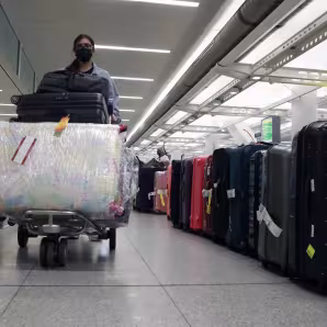 A person walks with luggage in John F. Kennedy International Airport in New York City.