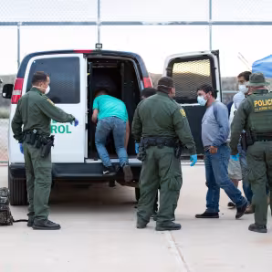 U.S. Border Patrol agents prepare to transport unauthorized migrants to Mexico under Title 42.