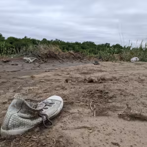 An abandoned shoe lies in the mud along the U.S.-Mexico border.