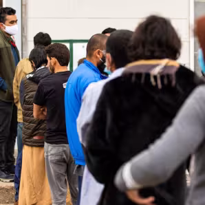 Afghan parolees wait in line at Fort McCoy, Wisconsin.