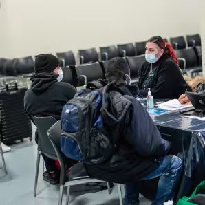 Asylum seekers receive assistance at the Brooklyn Cruise Terminal in New York City.