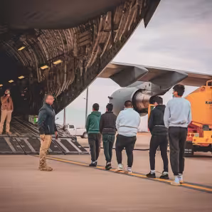 Noncitizens being deported to Ecuador board a military plane in Texas.