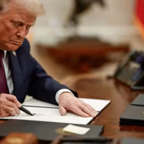 President Donald Trump signs an executive action