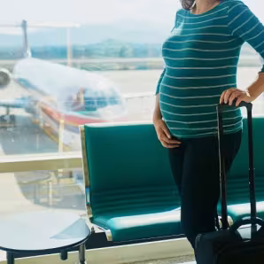 A pregnant woman at an airport.