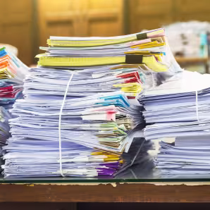A pile of documents on a desk.