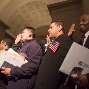 New U.S. citizens take an oath during a naturalization ceremony.