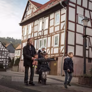 A family from Syria walks through the town of W&auml;chtersbach, Germany, where they now live.