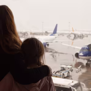 A woman and child watch airplanes