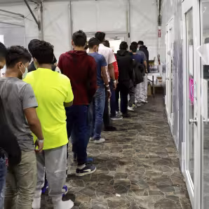 Unaccompanied minors undergo processing at a temporary facility in Texas.