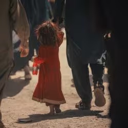 A young girl crossing the border into Afghanistan.