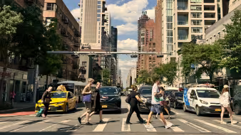 People at a pedestrian crosswalk crossing the street