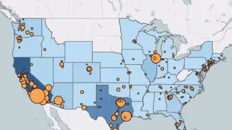 A U.S. map with states in different shades of blue and orange circles on certain metro areas