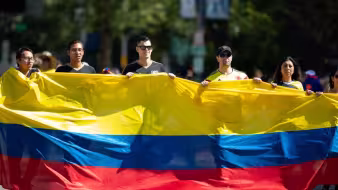 People carry a giant Colombian flag at a parade in Washington, DC