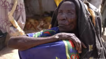 An elderly refugee woman