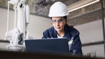 An industrial engineer working in a robotics factory.